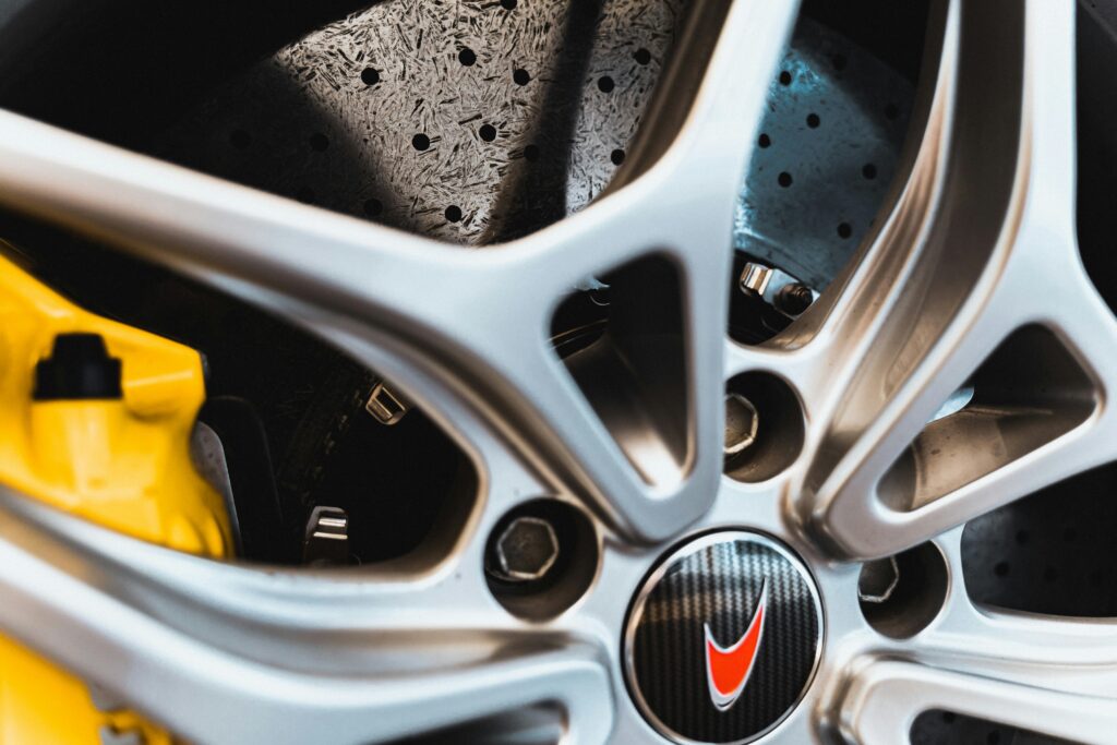 Detailed close-up of a high-performance car wheel with yellow brake calipers.